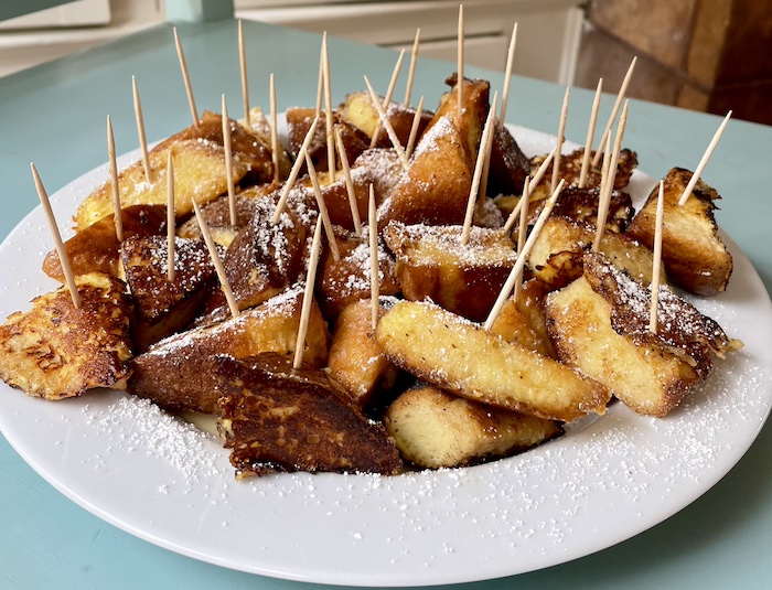 Gluten-free brioche French toast bites with toothpicks for fork-free eating